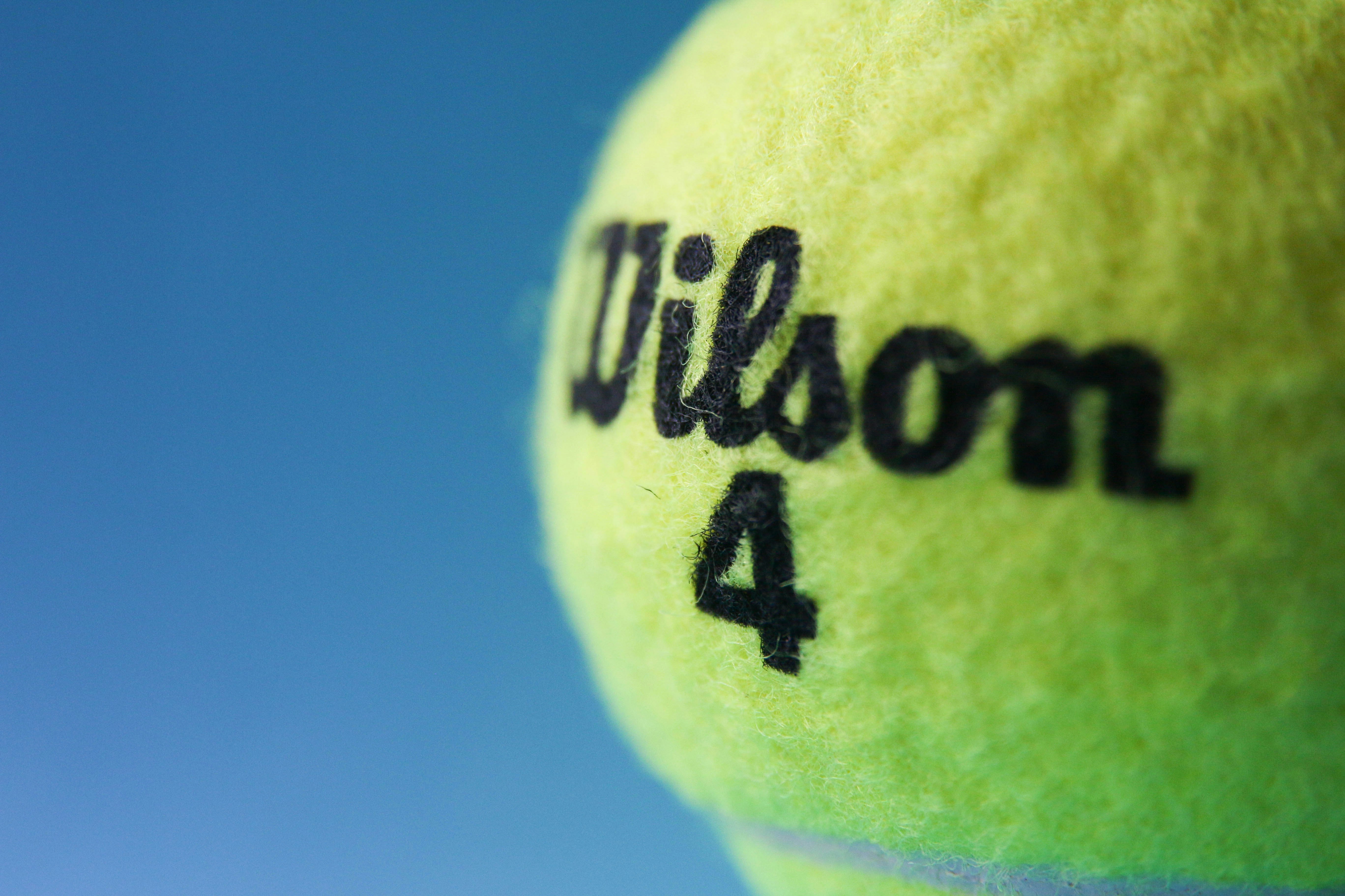 green tennis ball on blue background